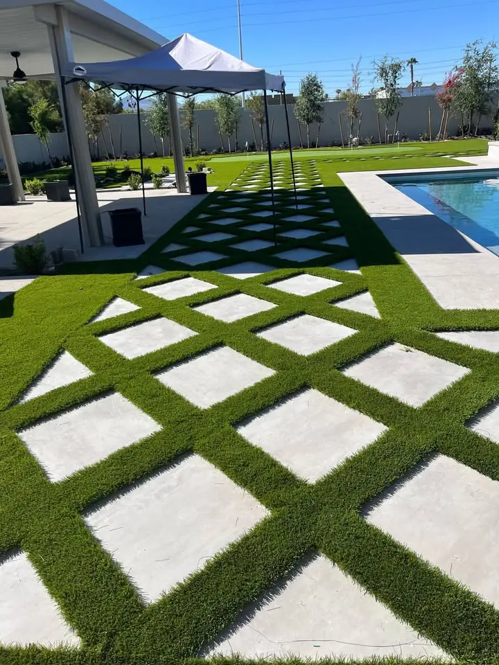 artificial turf and pavers freshly installed at a home in Gilbert AZ. Next to pool with putting green in the background
